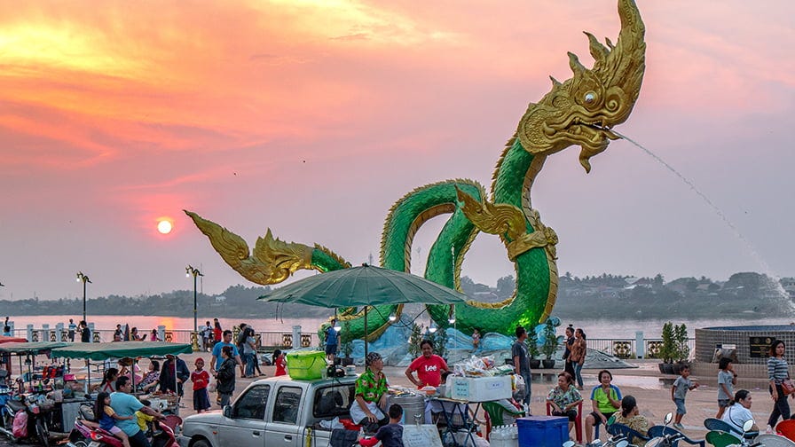 Locals enjoy the evening festivities on the Mekong waterfront.